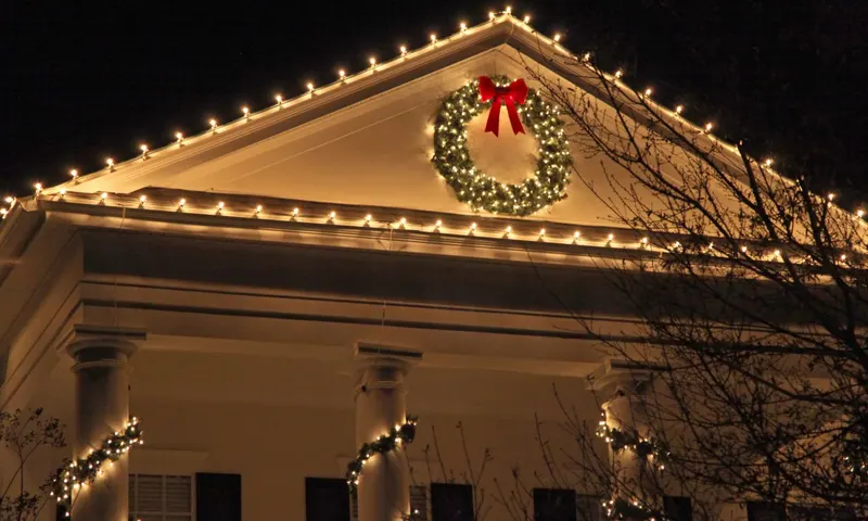 Lit wreath with a red bow on a white pediment, C9 bulbs along the roof edge, Portland